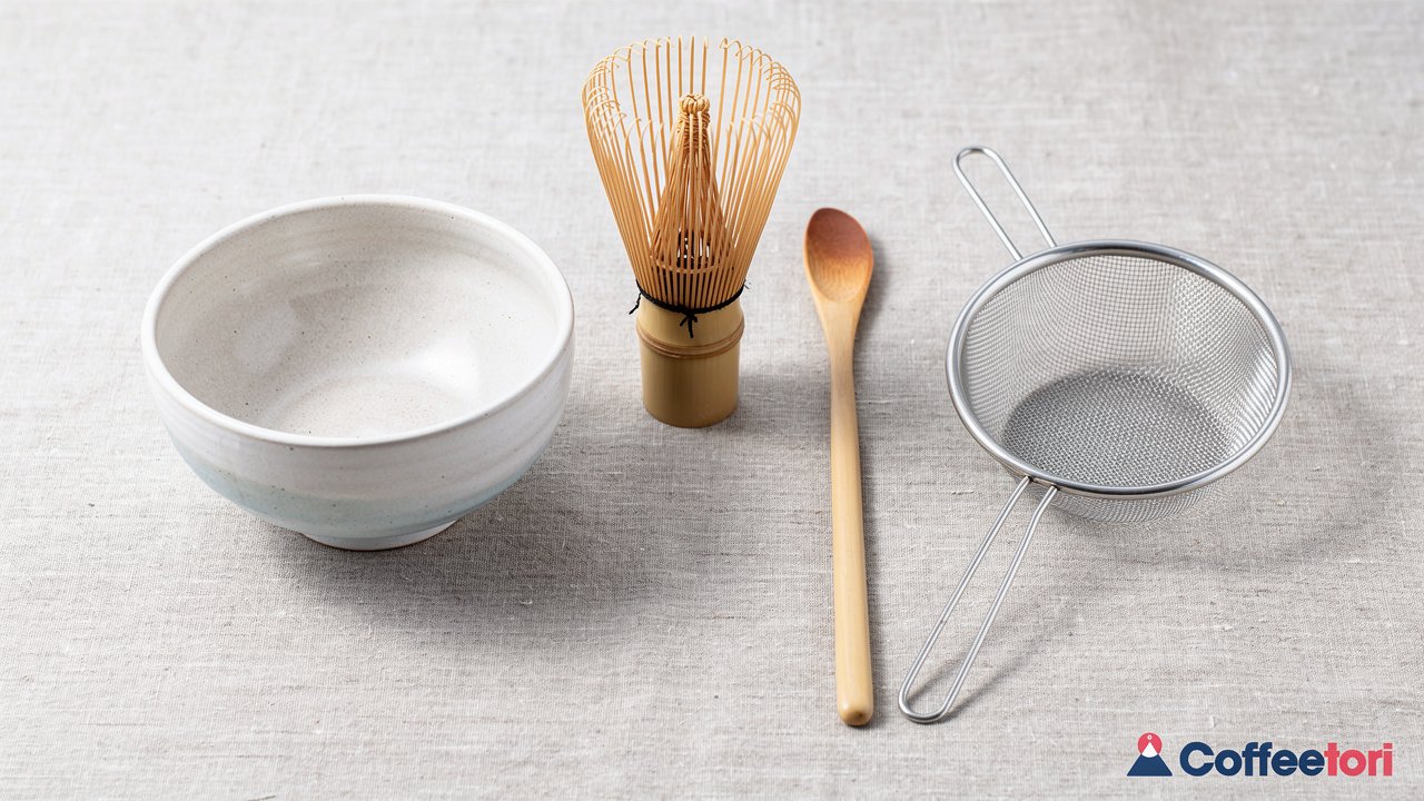 Four traditional matcha tools arranged on linen surface